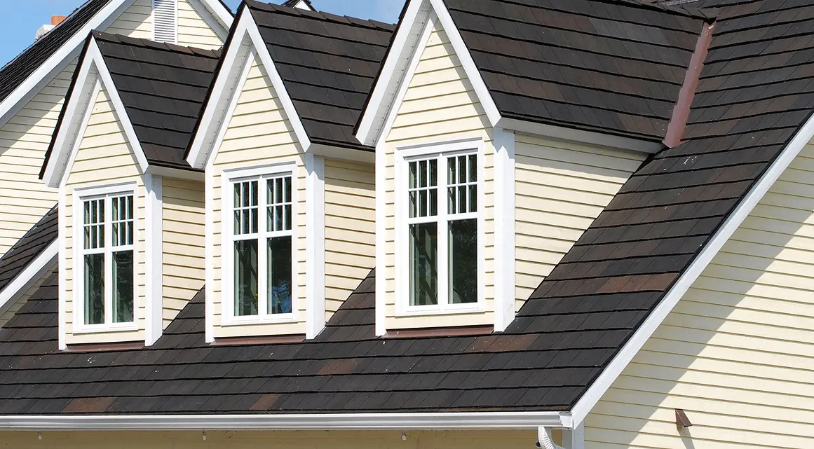 Yellow house with three dormer windows
